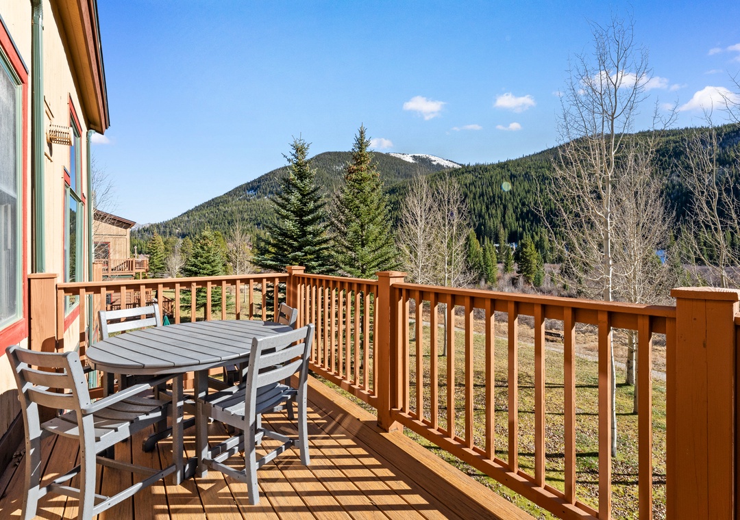 Enjoy your morning coffee on this private deck with stunning mountain views and forest backdrop.