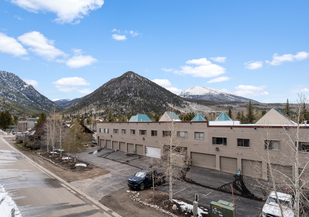 Property nestled in a mountain valley surrounded by stunning peaks and natural landscape, offering scenic views of the area and nearby wilderness.