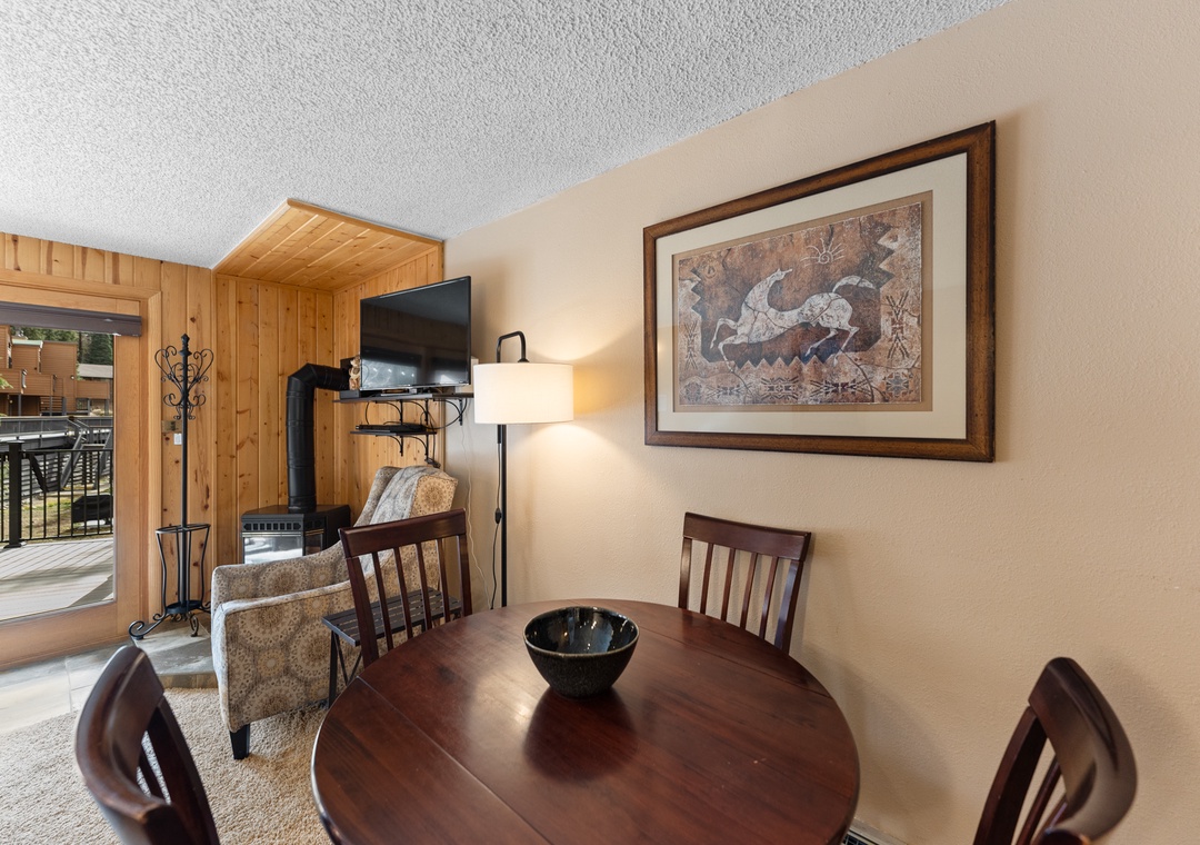 Gather around your cozy dining table with mountain views streaming through sliding doors to your private balcony.
