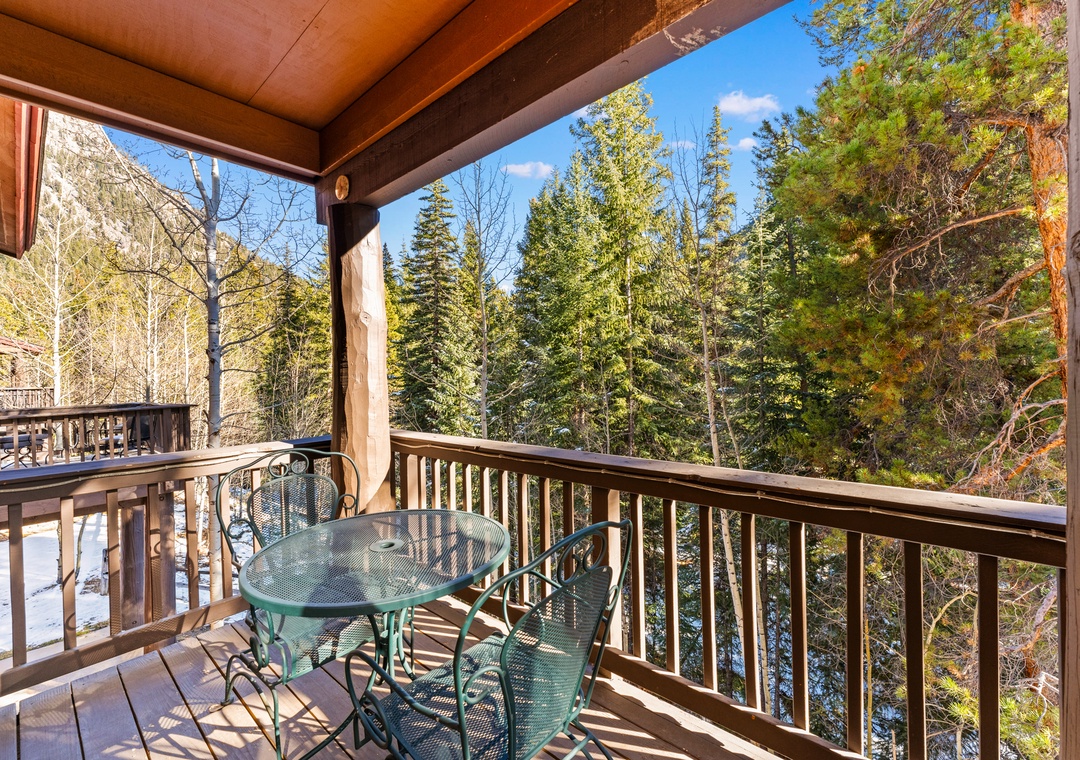 Your private mountain retreat balcony offers stunning forest views and peaceful mornings with coffee surrounded by towering pines.