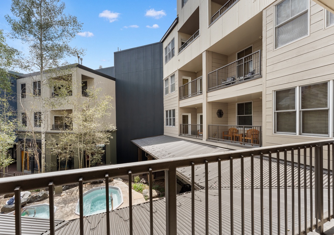 Step onto your private balcony and enjoy peaceful views of the courtyard pool and surrounding buildings.