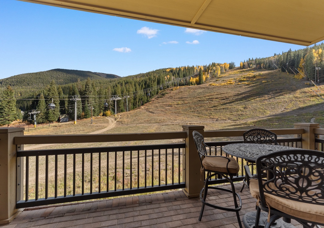Your private balcony offers stunning mountain views with autumn colors painting the slopes. Relax at the outdoor table and breathe in the crisp mountain air.