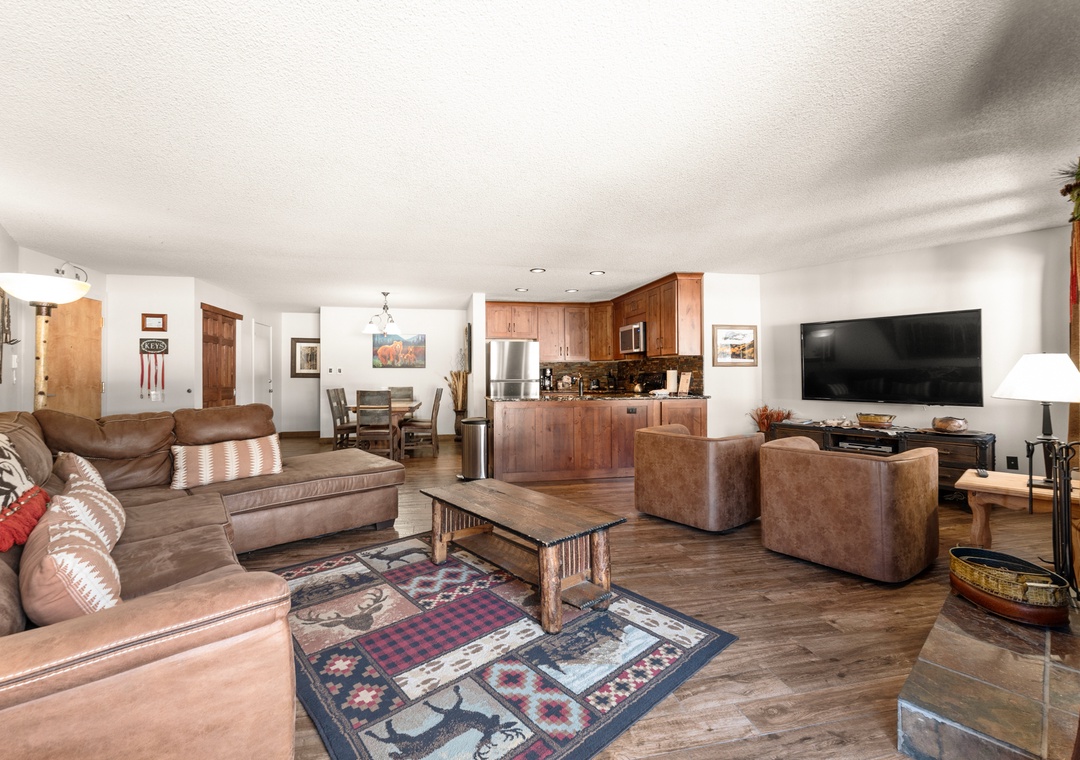 Sink into plush leather seating in your spacious open-concept living area, complete with full kitchen and modern entertainment center for perfect mountain getaway evenings.