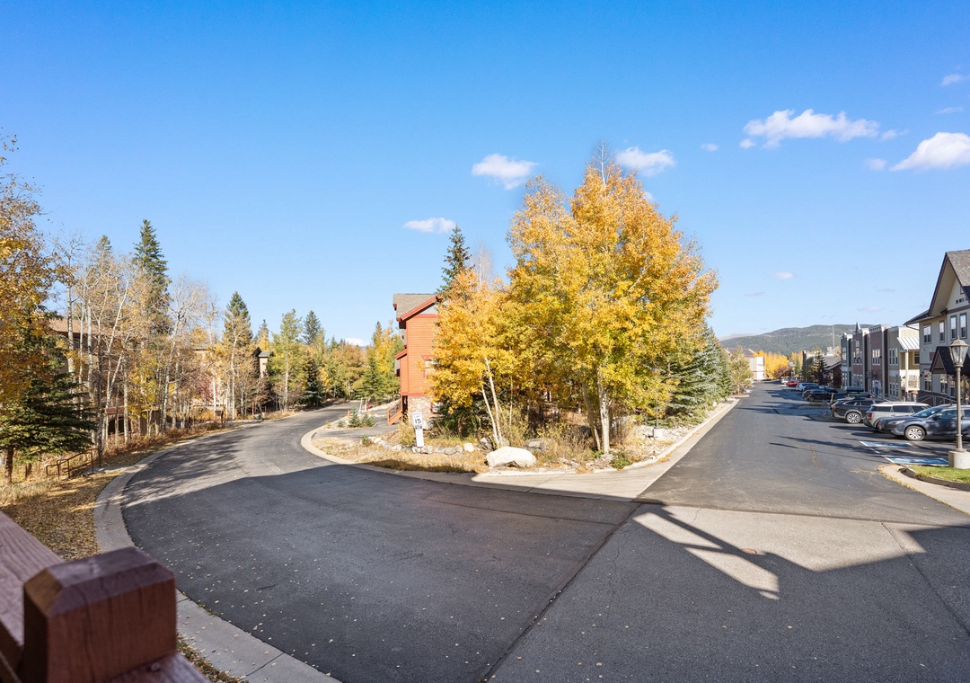 A peaceful residential neighborhood with vibrant autumn foliage and mountain views creates a serene setting for the property.