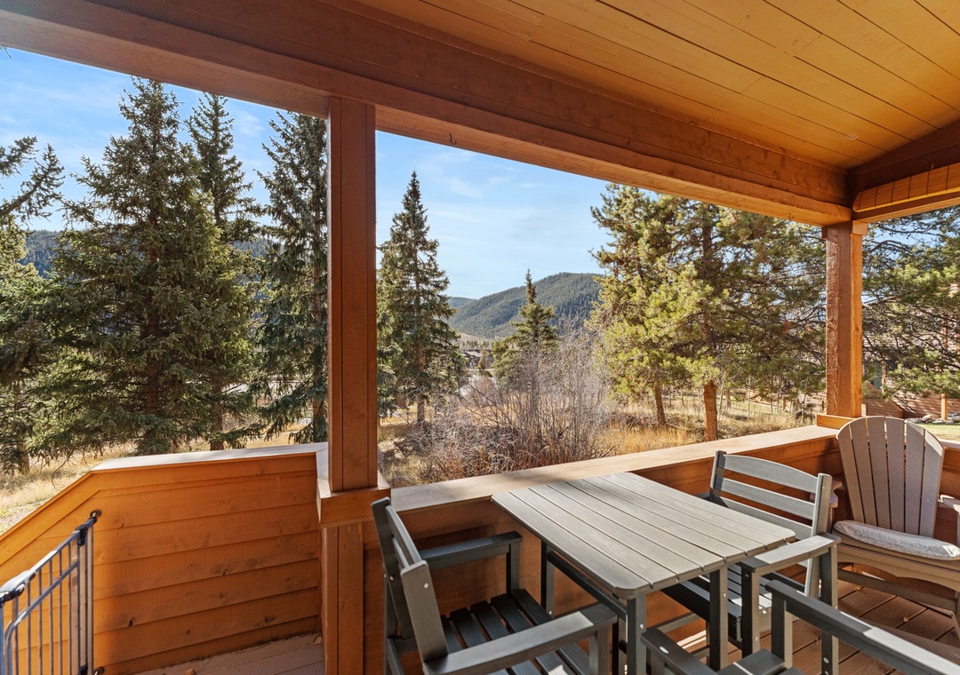 Peaceful mountain views frame this covered balcony, where you can enjoy your morning coffee surrounded by evergreens and open skies—perfect for unwinding in nature's embrace.