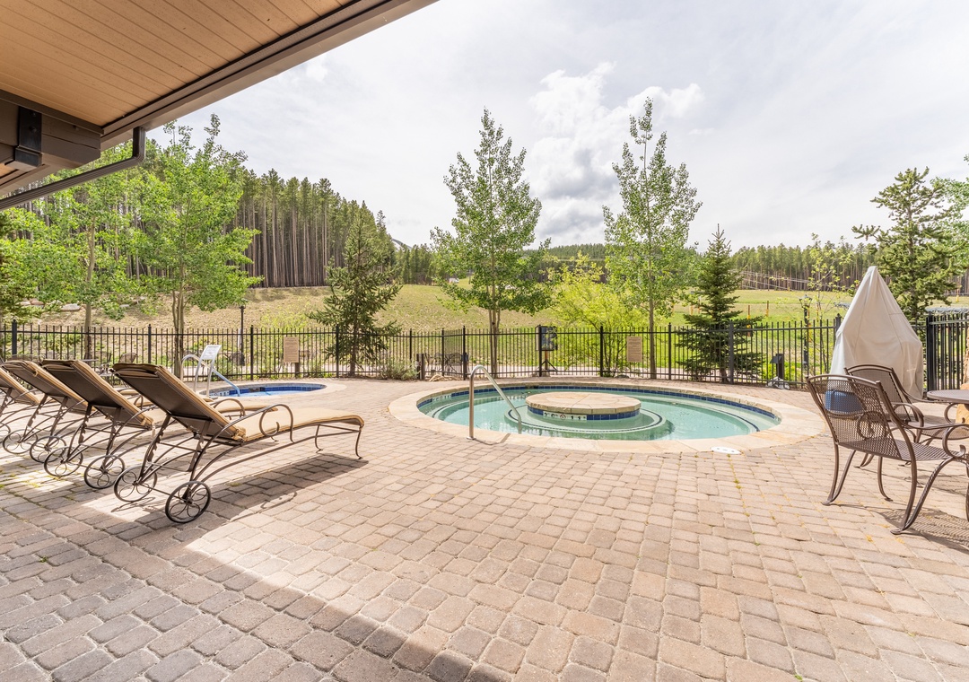 Soak in your private hot tub surrounded by forest views, with comfortable loungers for complete relaxation.