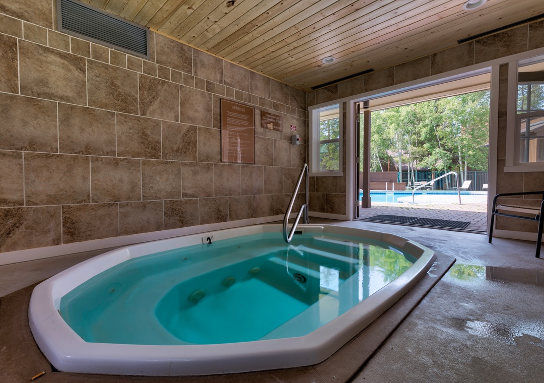 Unwind in your private hot tub sanctuary, where warm bubbling waters and peaceful poolside views create the perfect retreat.