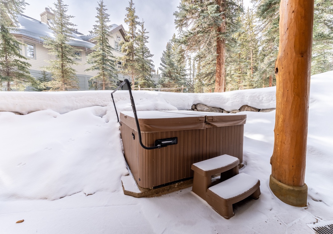 Soak in the private hot tub surrounded by snowy pines—your perfect winter retreat awaits.