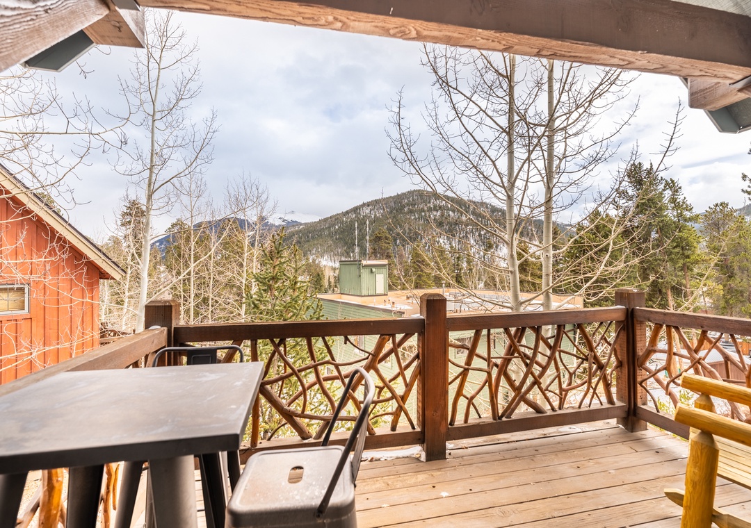 Enjoy your morning coffee on this charming wooden deck with stunning mountain views stretching across the horizon.