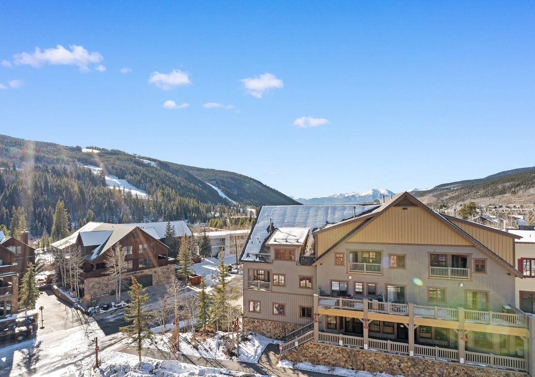 Mountain village setting with ski slopes and forested peaks creating a perfect alpine backdrop for winter adventures.