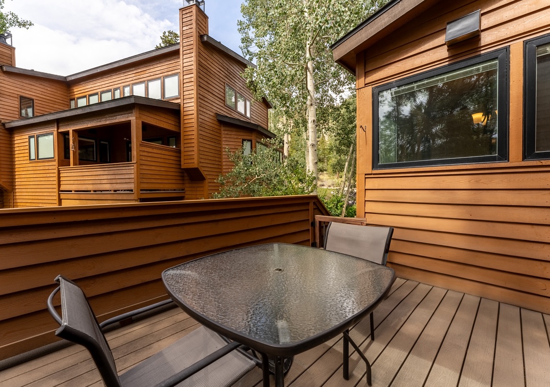 Enjoy morning coffee and evening meals on your private deck, surrounded by warm wood siding and peaceful nature views.