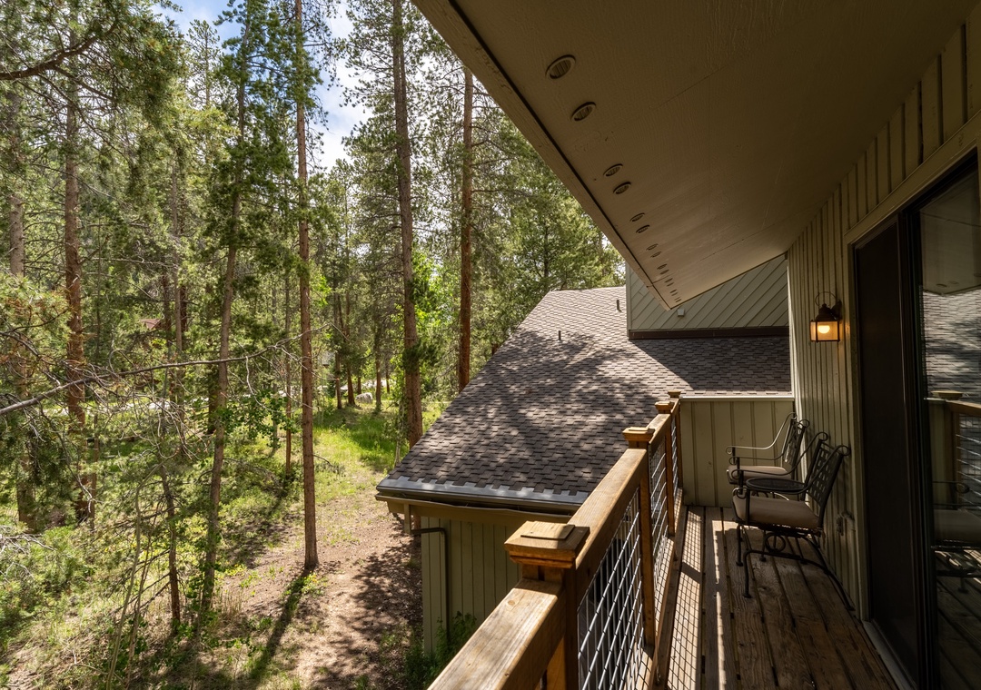 Step onto your private balcony and breathe in the fresh forest air while enjoying serene views of towering pines surrounding your retreat.