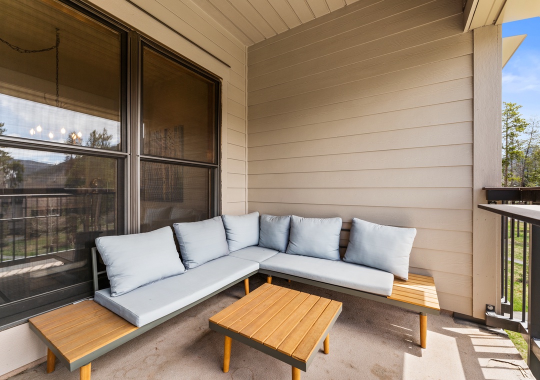 Unwind on your private covered balcony with plush seating and peaceful views through floor-to-ceiling windows.