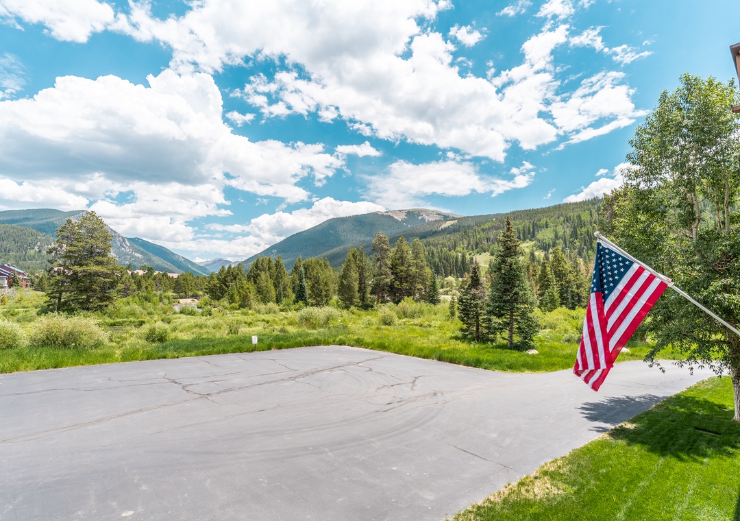 Mountain valley setting with forested hillsides and open meadows creating a scenic backdrop for the property.