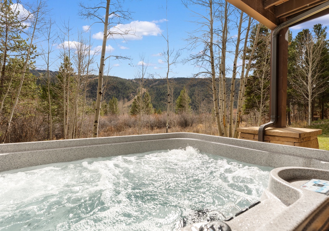 Soak in bubbling warmth while your eyes trace mountain ridges and aspen groves—your private hot tub frames nature's quiet beauty perfectly.