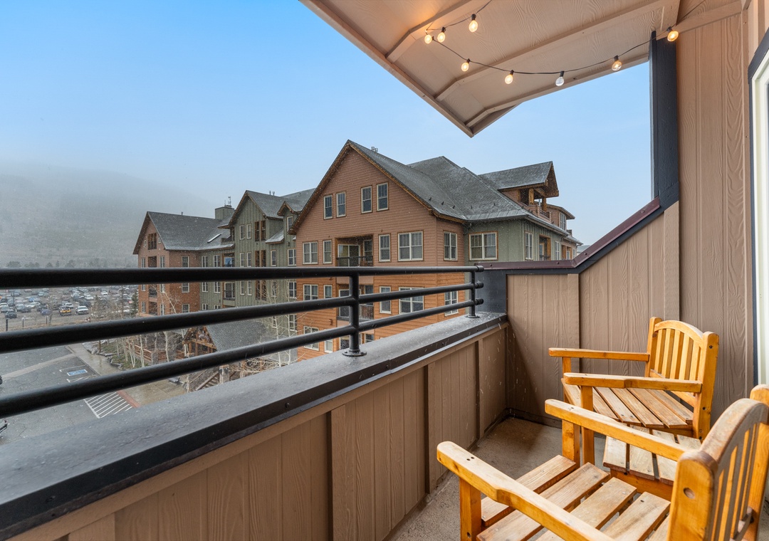 Unwind on your private balcony with cozy seating and twinkling string lights as you take in views of the charming neighborhood below.
