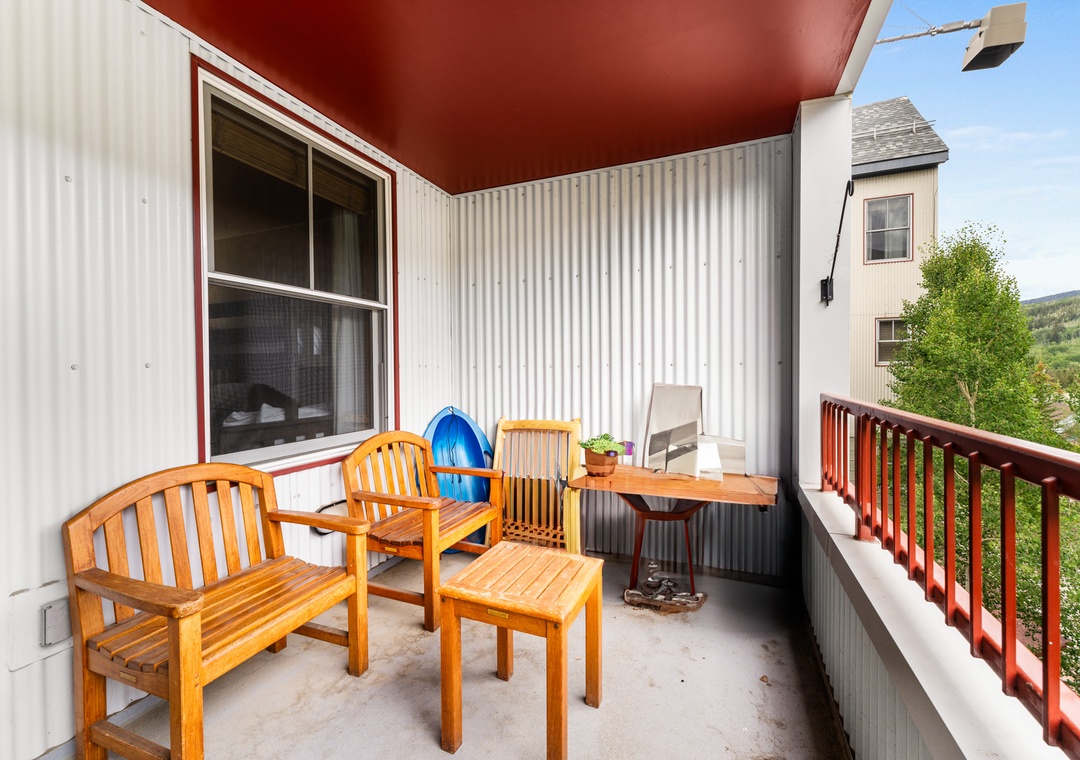 Relax on your private balcony with comfortable teak seating and scenic mountain views stretching beyond.