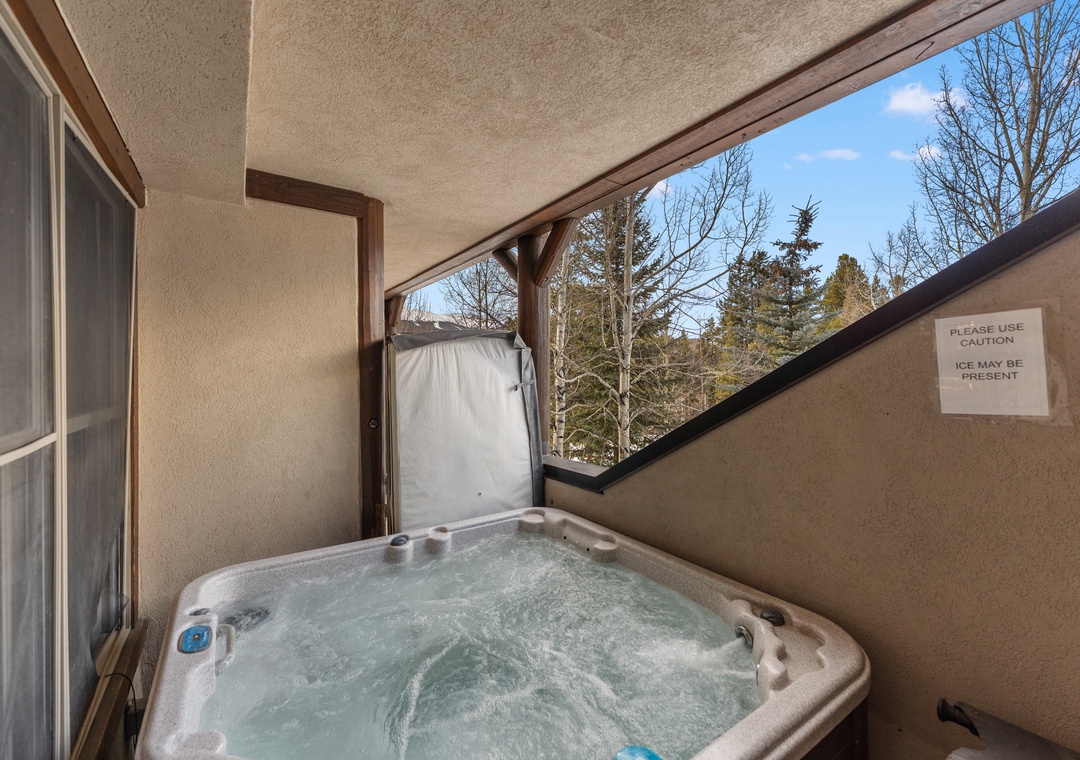 Soak in your private hot tub while gazing at the peaceful wooded surroundings.