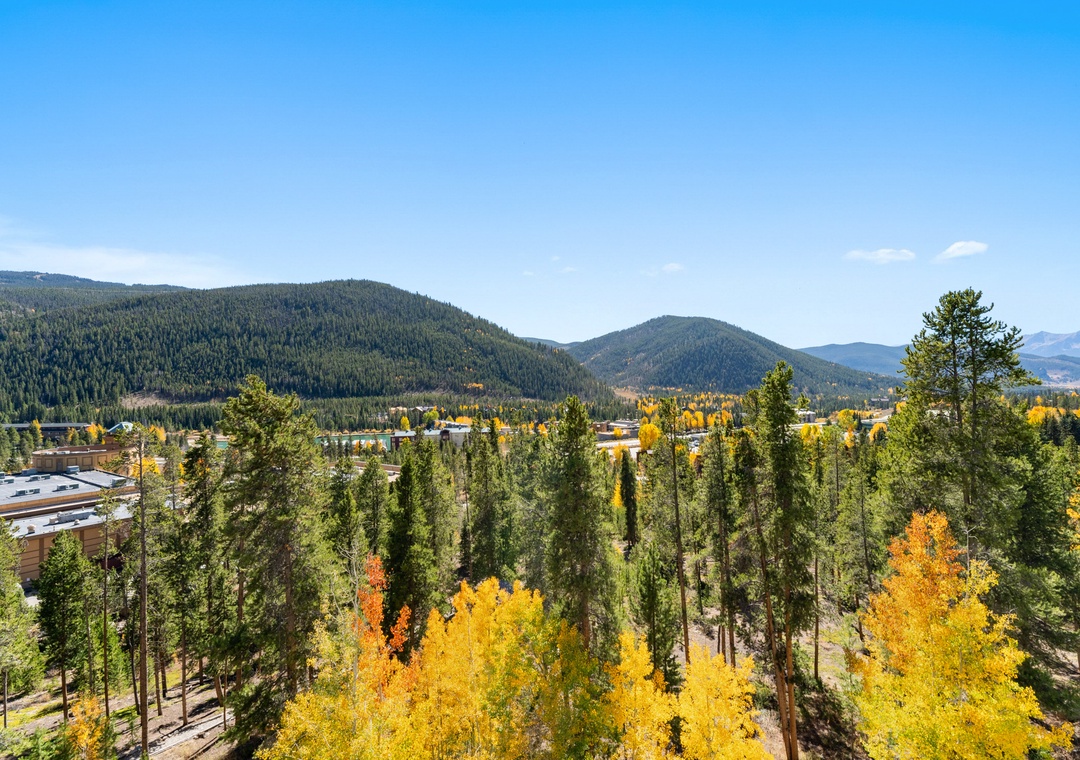 Stunning autumn mountain landscape with vibrant golden foliage surrounding the property area.