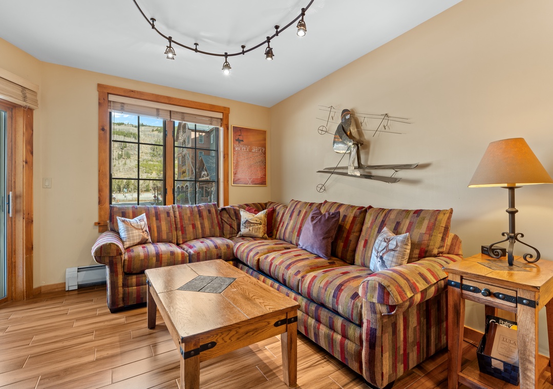 Sink into the colorful sectional and unwind after a day on the slopes. Natural light pours through large windows, while mountain-inspired decor adds a cozy alpine touch to your retreat.