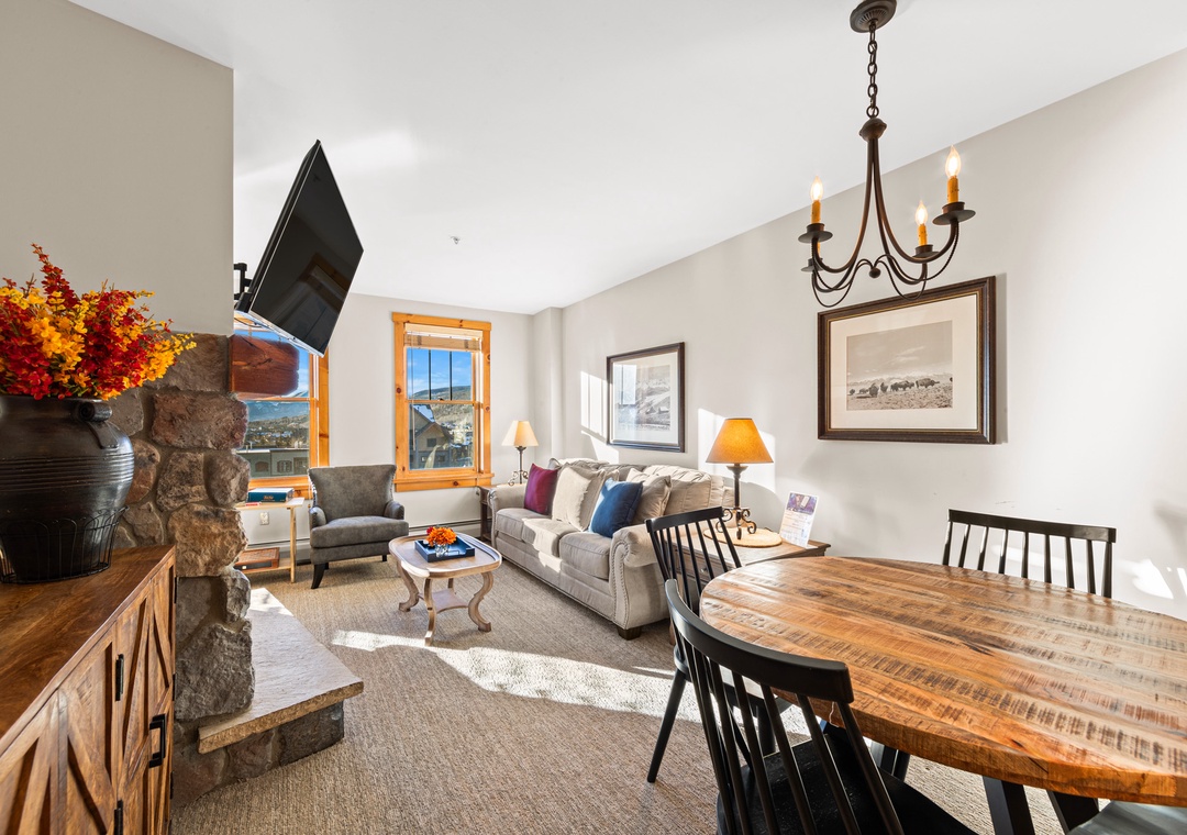 Relax in your spacious living room with cozy fireplace, comfortable seating, and dining table perfect for sharing meals together.