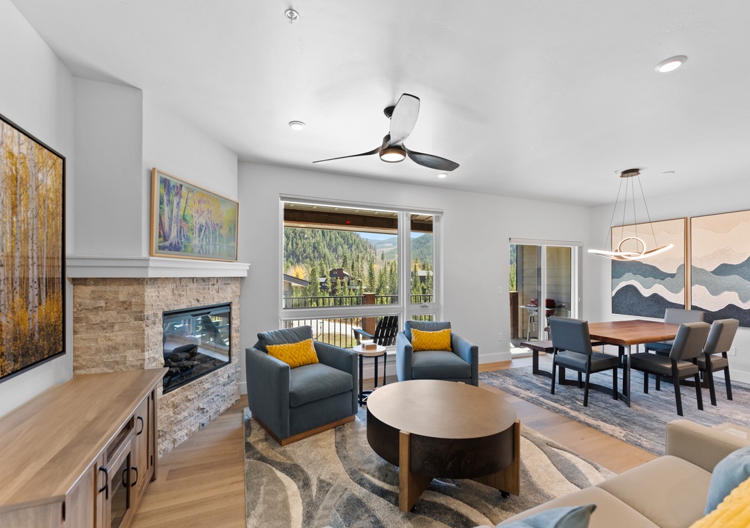 Sink into plush seating by your cozy fireplace while mountain views frame your perfect retreat through expansive windows.