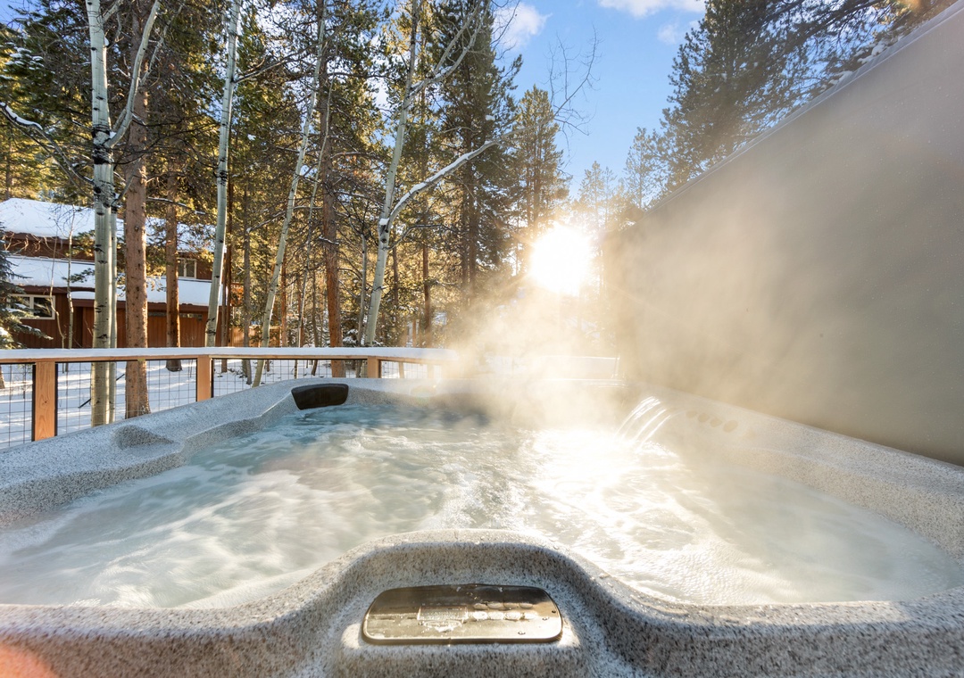 Soak in your private hot tub as winter sun filters through snow-dusted trees, creating pure mountain magic.