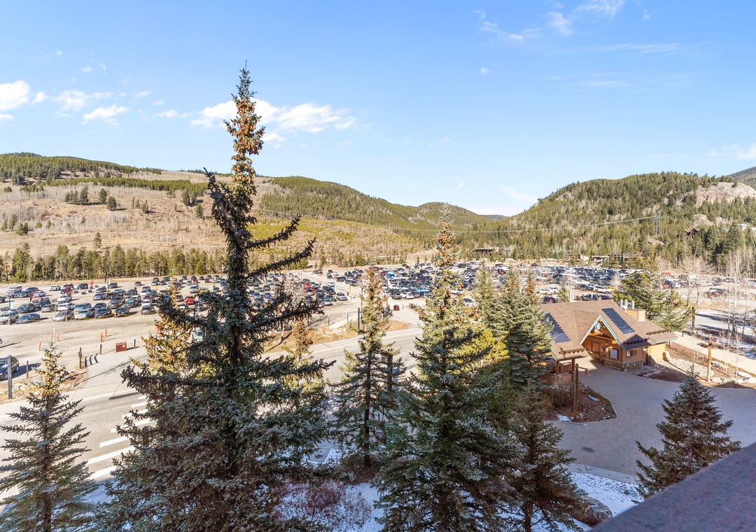Panoramic mountain valley setting with convenient parking and forested hillsides creating a peaceful alpine atmosphere.