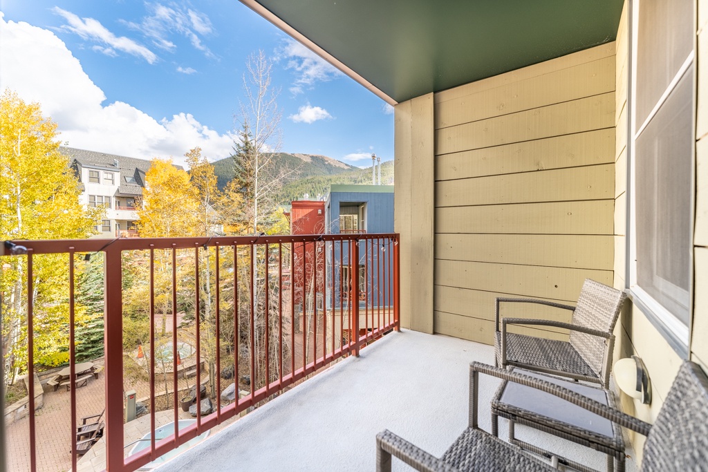 Sip your morning coffee on this cozy balcony while soaking in stunning mountain views and vibrant autumn colors.