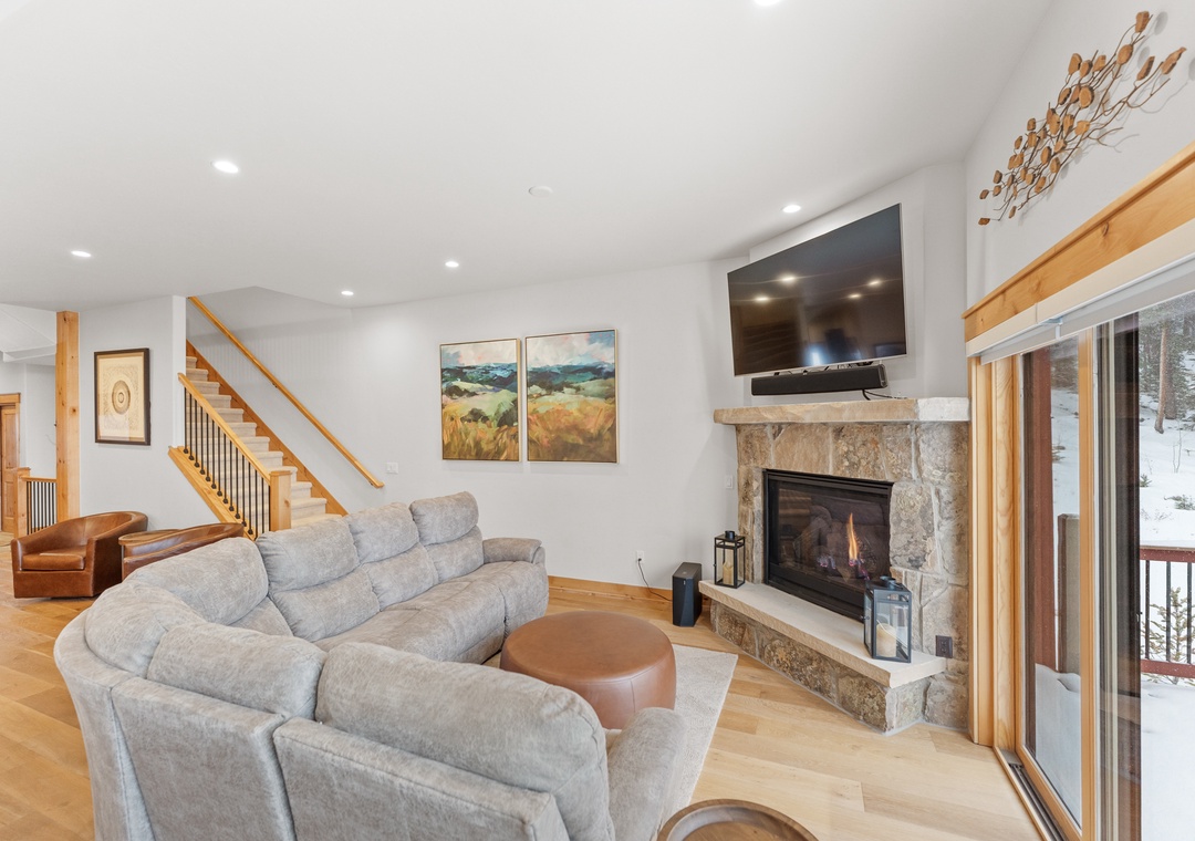 Sink into plush sofas by your crackling stone fireplace, where mountain views and cozy warmth create perfect après-ski moments.