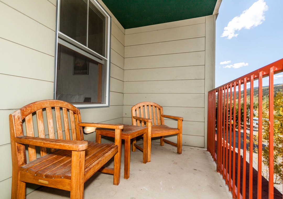 Step onto your private balcony with comfortable wooden furniture where you can sip morning coffee while enjoying peaceful views.