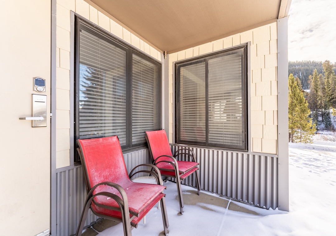 Step onto your private balcony where two comfortable chairs await, perfect for sipping morning coffee while gazing at the snowy forest landscape.