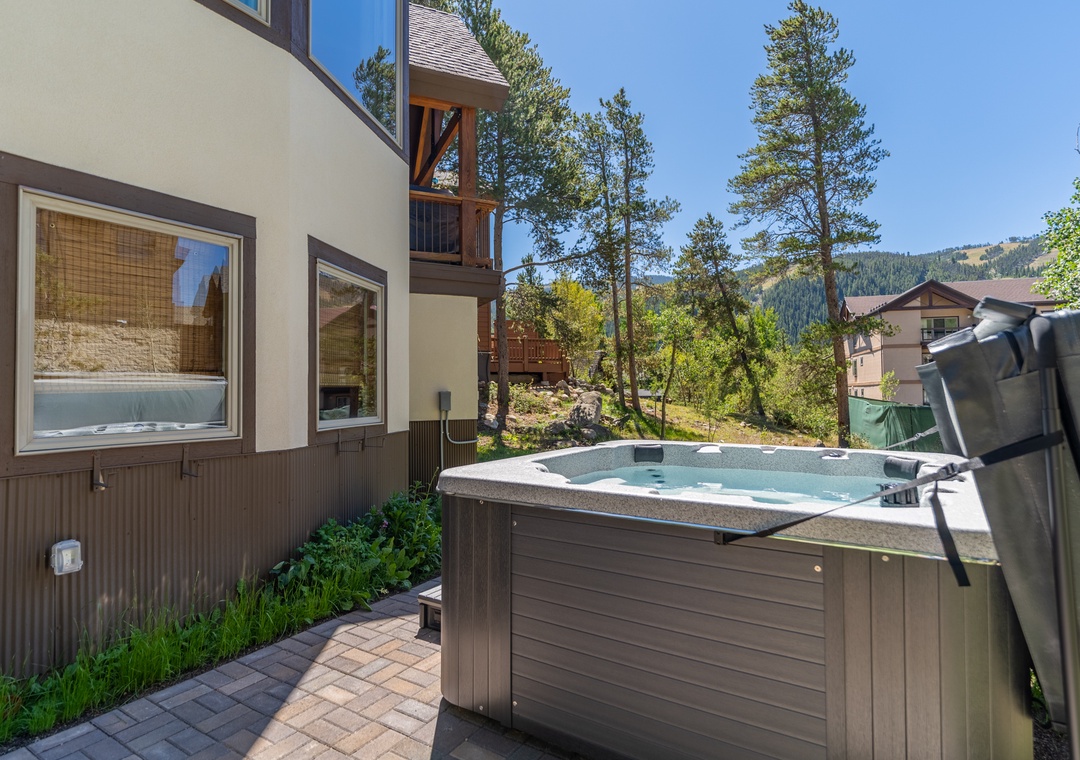 Unwind in your private hot tub surrounded by towering pines and mountain views, creating the perfect alpine retreat.