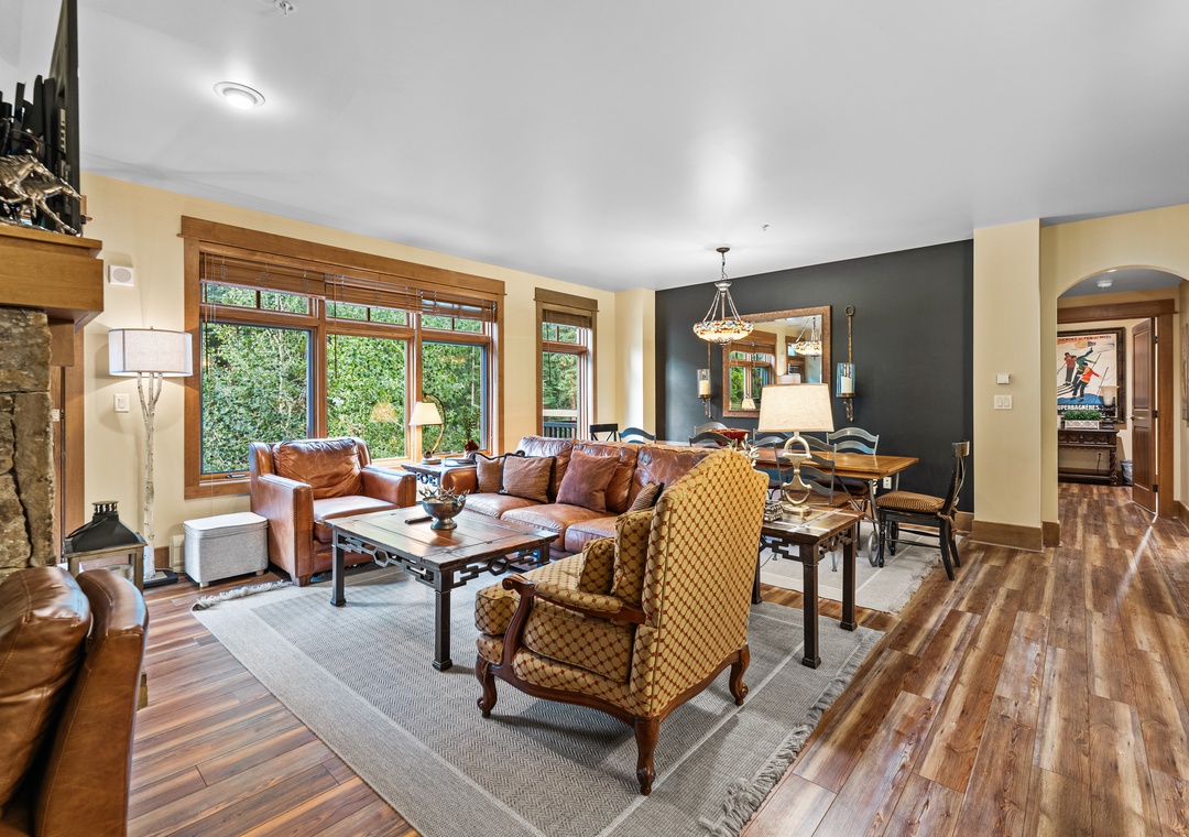 Sink into plush leather seating by your crackling fireplace, where warm wood tones and elegant furnishings create your perfect retreat.