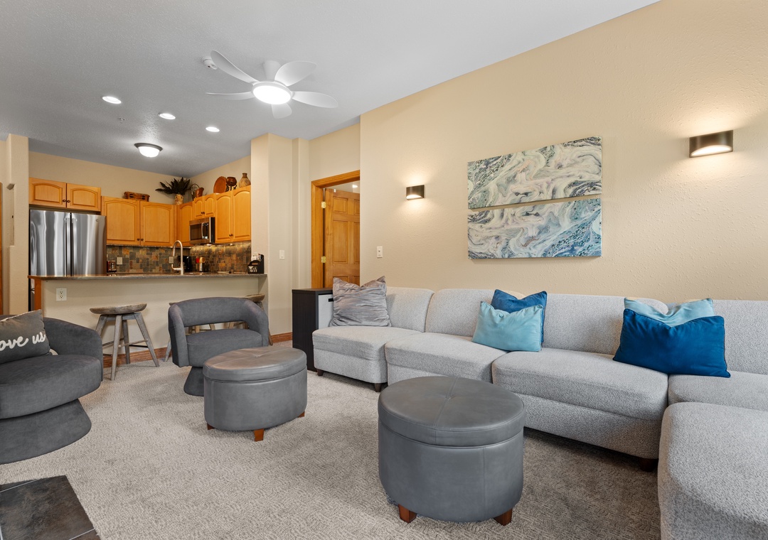 Settle into your inviting living space with plush seating and coastal accents. The open layout connects you to the kitchen, perfect for relaxing evenings together.