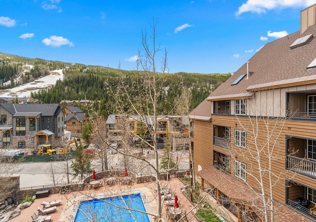Mountain resort community with swimming pool and ski slope access for an alpine getaway experience.
