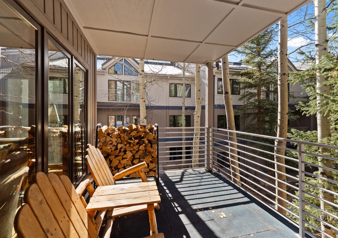 Step onto your private covered terrace and breathe in the fresh mountain air while relaxing on cozy wooden chairs.