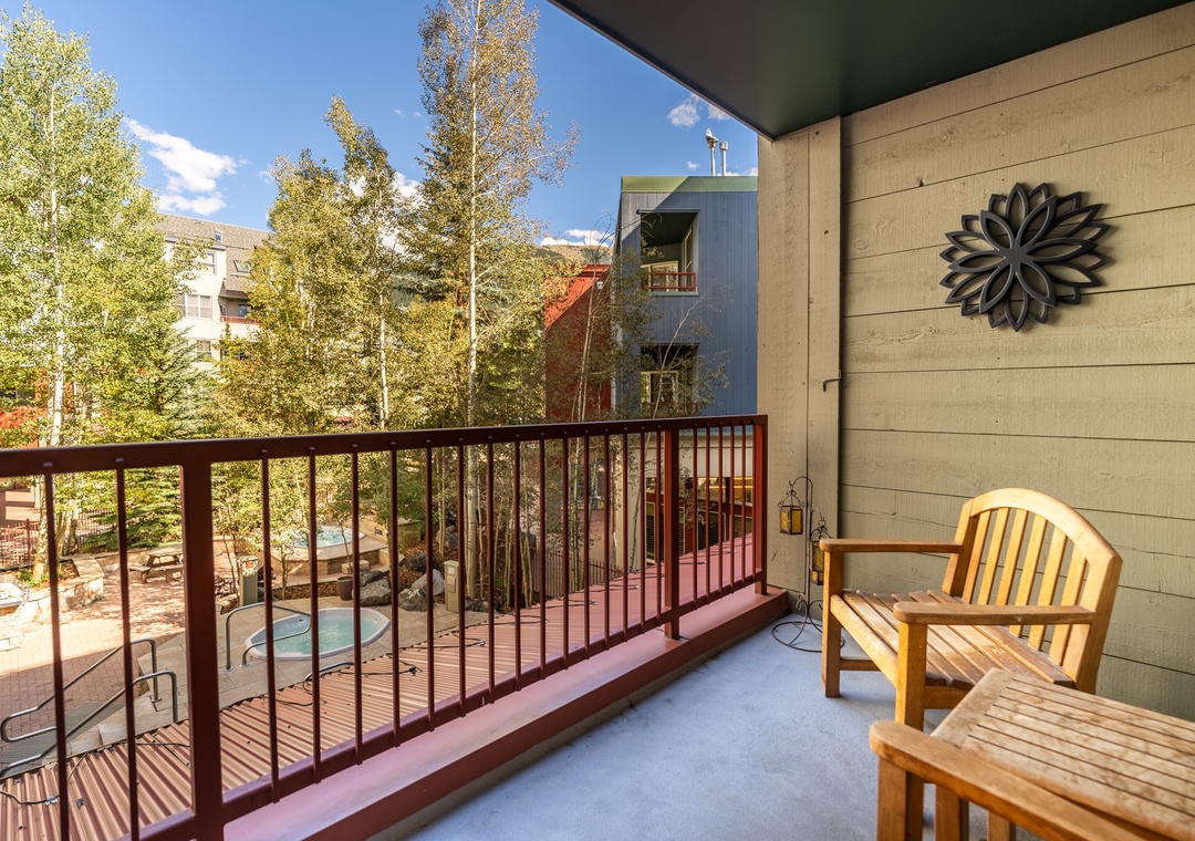 Step onto your private balcony with teak furniture and enjoy poolside views surrounded by autumn trees and mountain scenery.