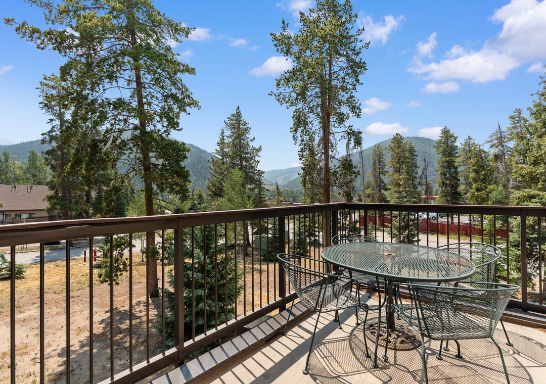 Enjoy your morning coffee at this private balcony table while taking in the breathtaking mountain and forest views—a peaceful retreat surrounded by towering pines and fresh air.
