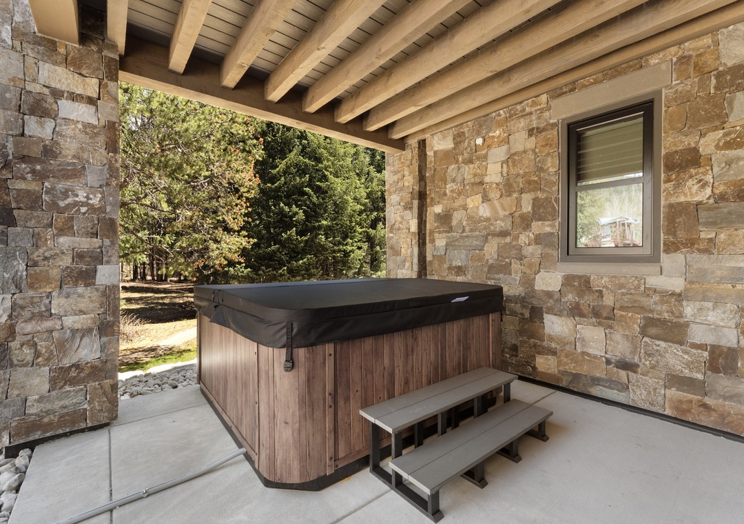 Soak your worries away in your private hot tub, sheltered beneath rustic beams with peaceful garden views stretching beyond.