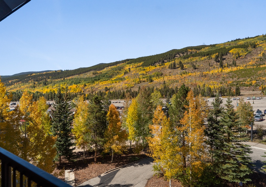 Mountain foothills dressed in brilliant autumn colors create a stunning seasonal backdrop for this peaceful valley setting.