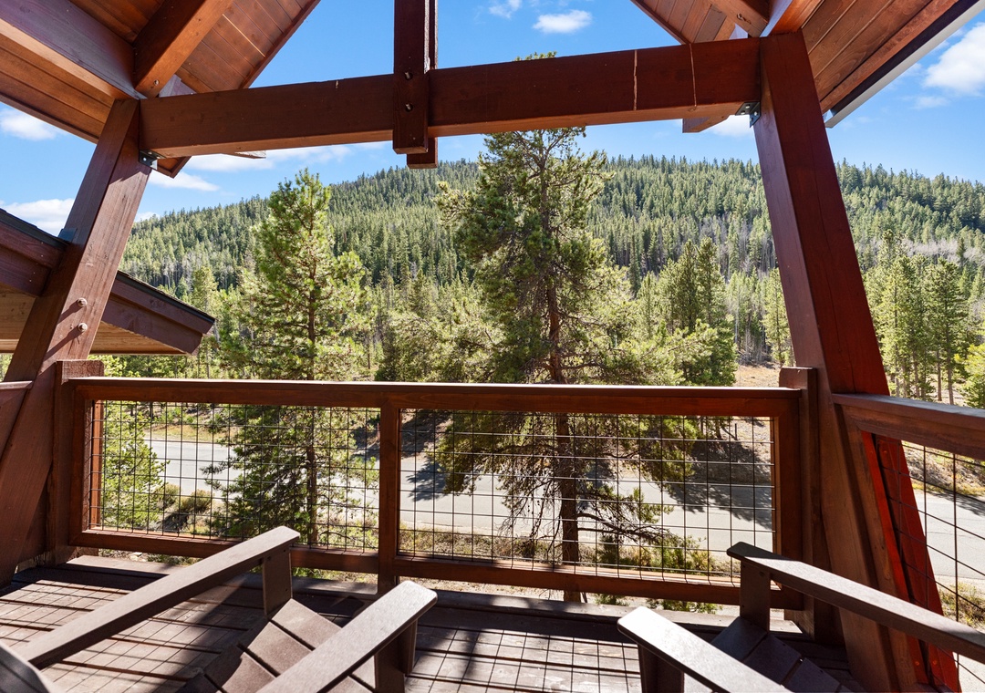 Relax on your private wooden deck where mountain vistas stretch endlessly before you through the open timber frame design.