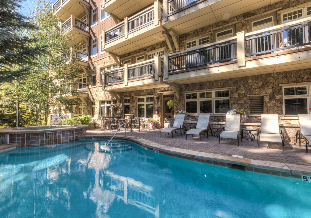 Soak up the sun on comfortable loungers beside your private pool, surrounded by natural stone architecture and mature trees.