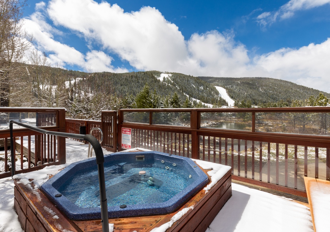 Soak in the steaming hot tub while gazing at snow-capped mountains and pristine ski slopes stretching before you.