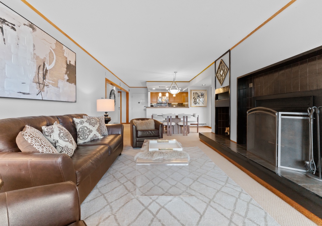 Relax on plush leather sofas by your cozy fireplace, with an open kitchen perfect for preparing meals together.