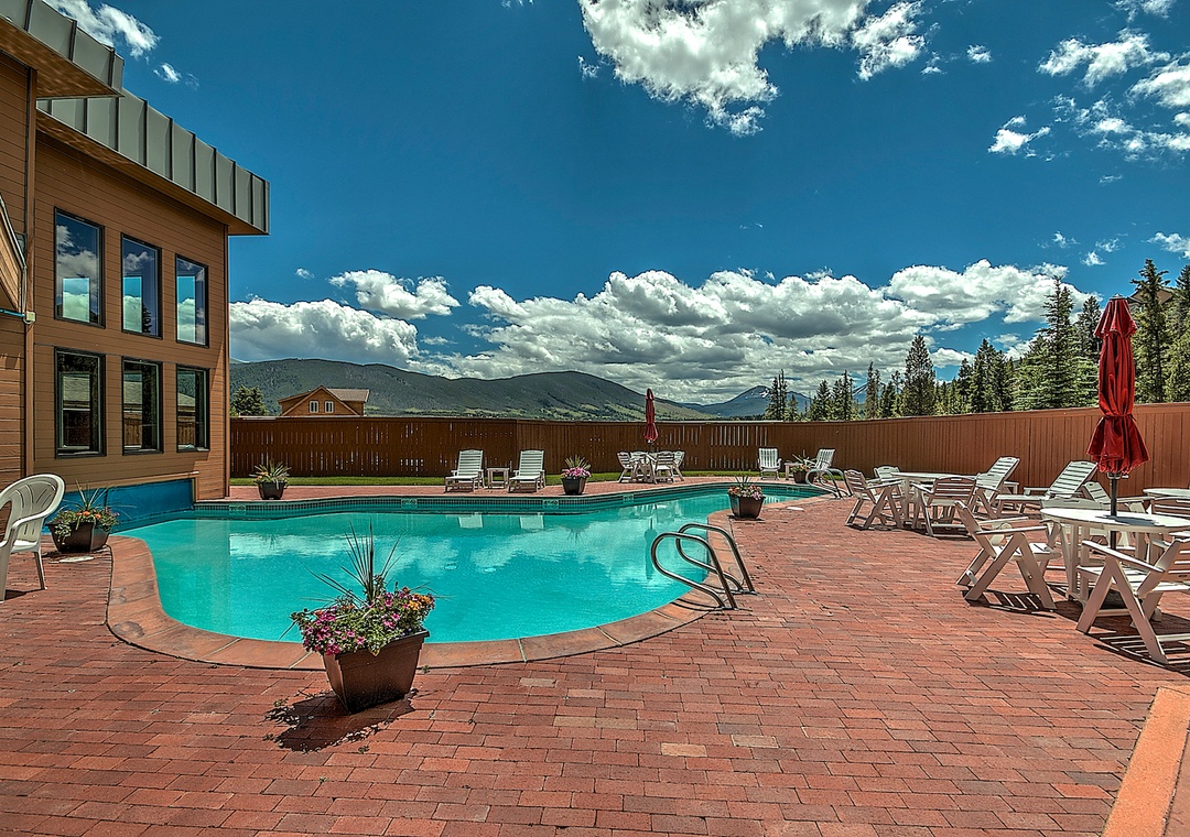 Dive into your private oasis with this pristine pool surrounded by stunning mountain views and comfortable loungers for perfect relaxation.