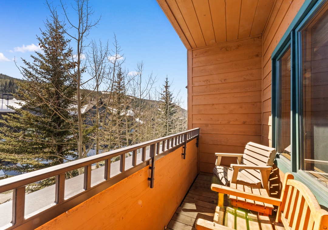 Bask in alpine sunshine on your private balcony, where wooden chairs invite you to sip morning coffee while gazing at snow-dusted peaks and evergreen forests.