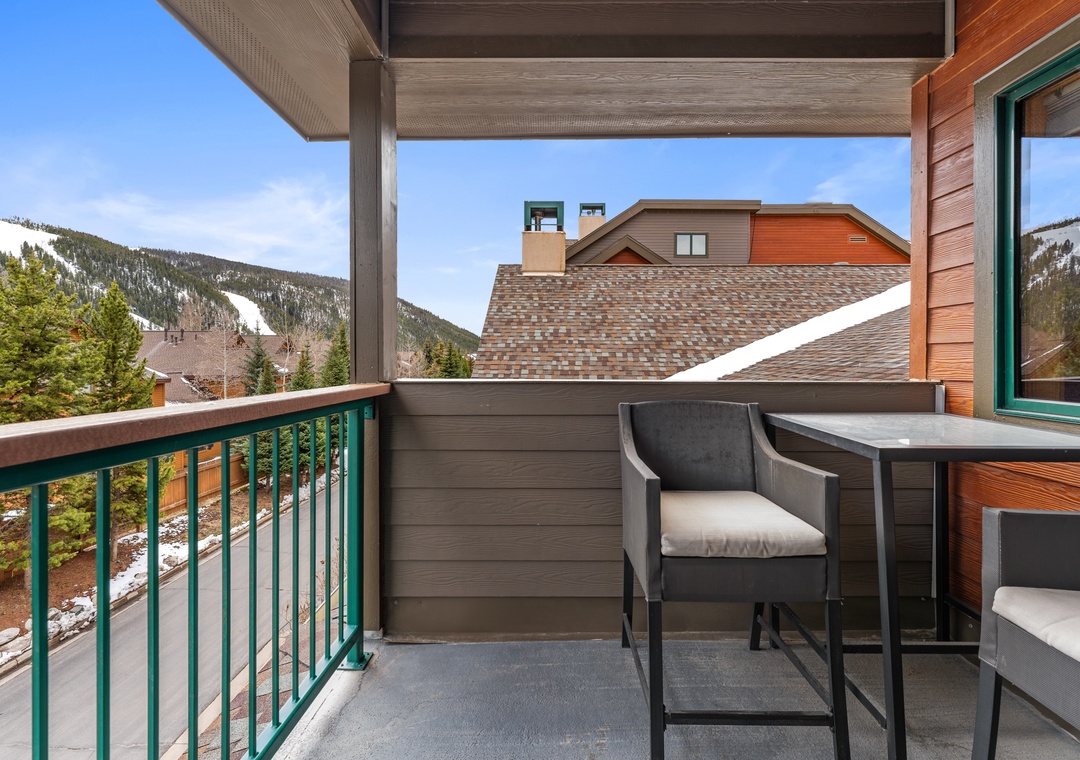 Savor morning coffee on your private balcony while admiring sweeping mountain views and cozy neighborhood homes below.