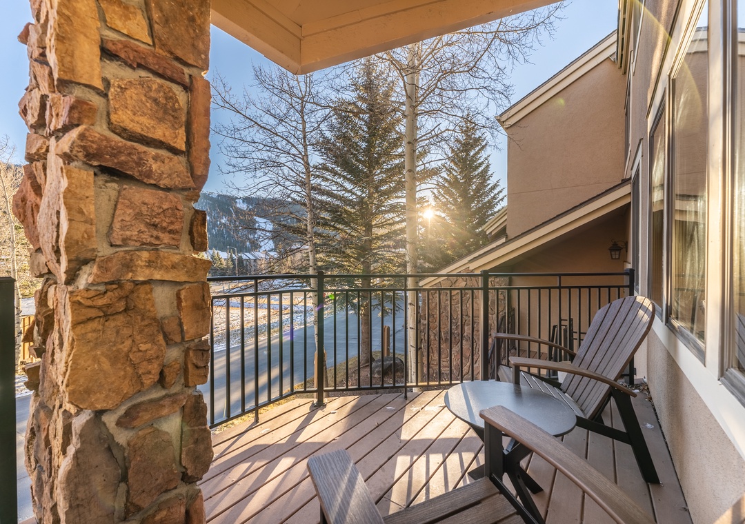 Step onto your private balcony where Adirondack chairs await your morning coffee ritual, framed by mountain views and warm winter sunlight.