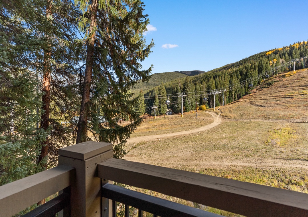 Your private balcony overlooks autumn ski slopes and forest-covered mountains, perfect for morning coffee with breathtaking views.